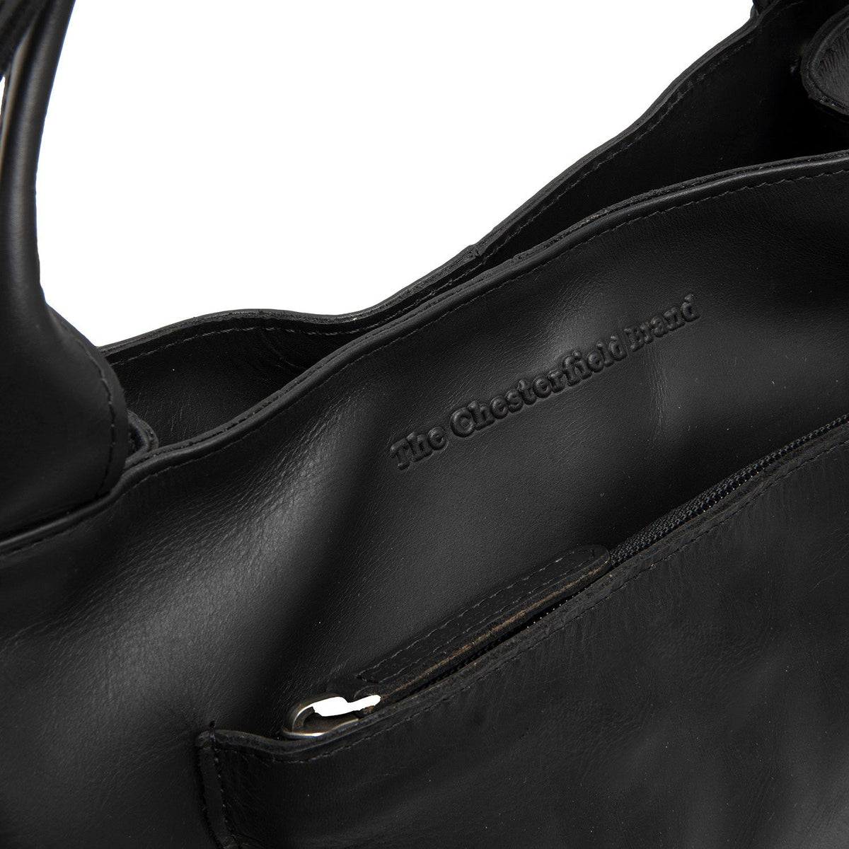 
Tenara Bolso de mano de cuero flor - Vista lateral mostrando el corte ergonómico de mangas